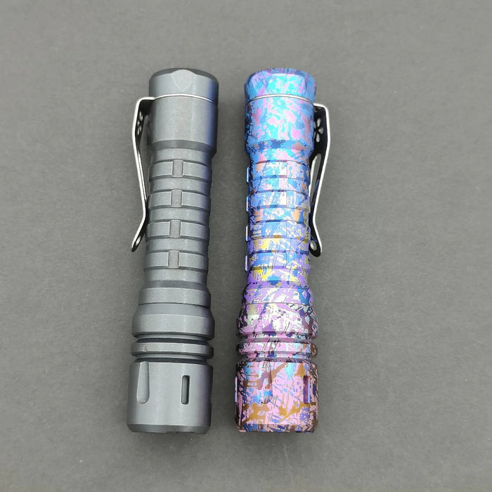 A pair of tactical flashlights include a matte black one with segmented grip and the ReyLight Anodized Ti LANapple, which flaunts a bright, textured splatter design. Both have belt clips and utilize an XPL HI 6000K LED for maximum brightness.