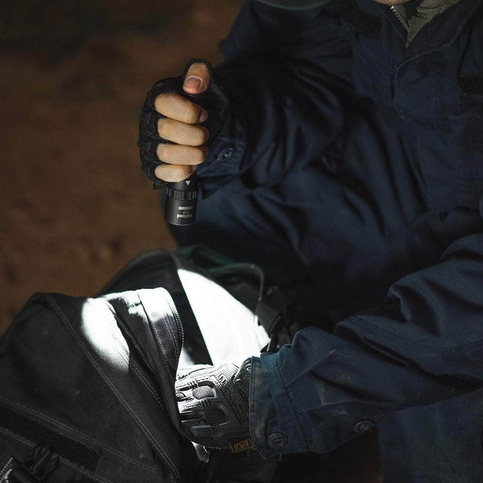 A man is holding a Weltool T17 flashlight in his pocket.