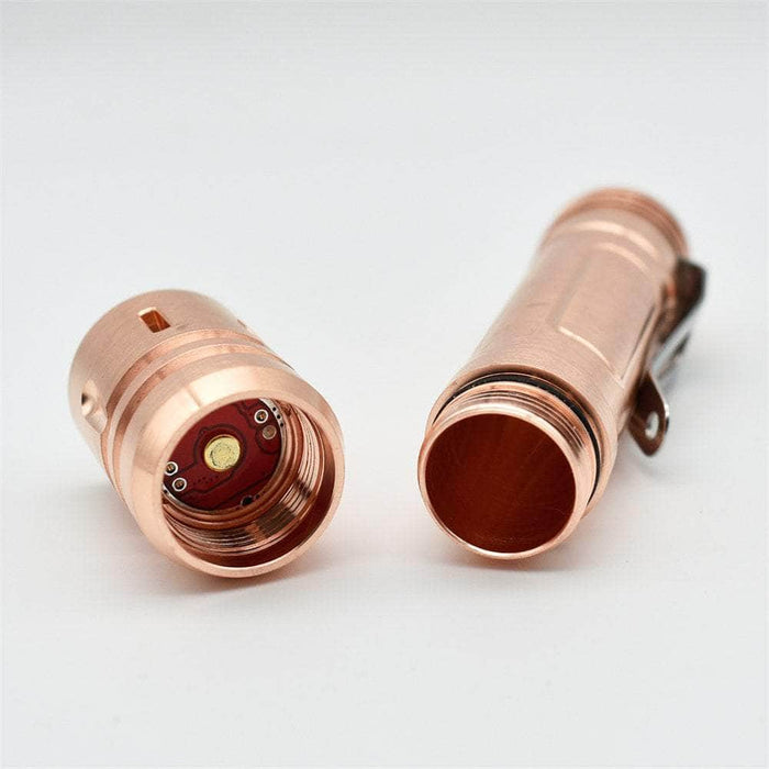 A pair of ReyLight LAN Copper led flashlights on a white surface.