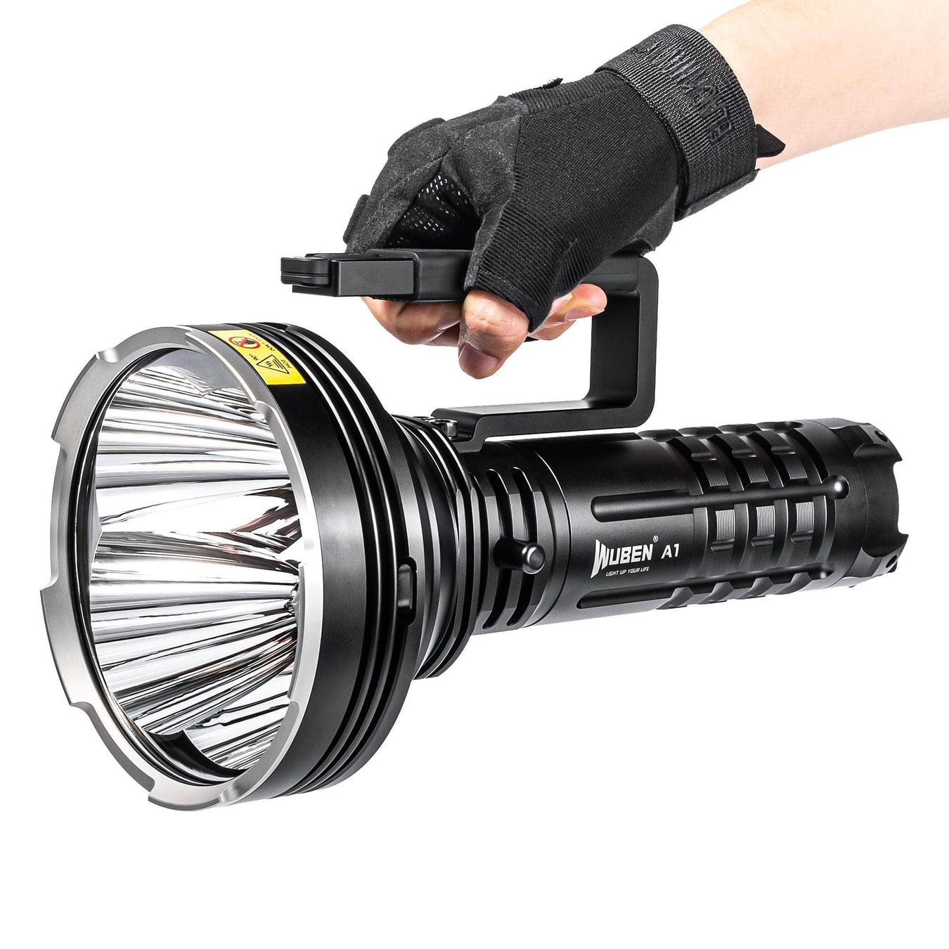 A gloved hand holding a large black Muben A1 flashlight with a handle, featuring a wide reflective lens and warning label.