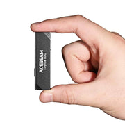 A hand holds the Acebeam Keylite 500 USB-C Keychain Light, a small rectangular black flashlight, against a white background.