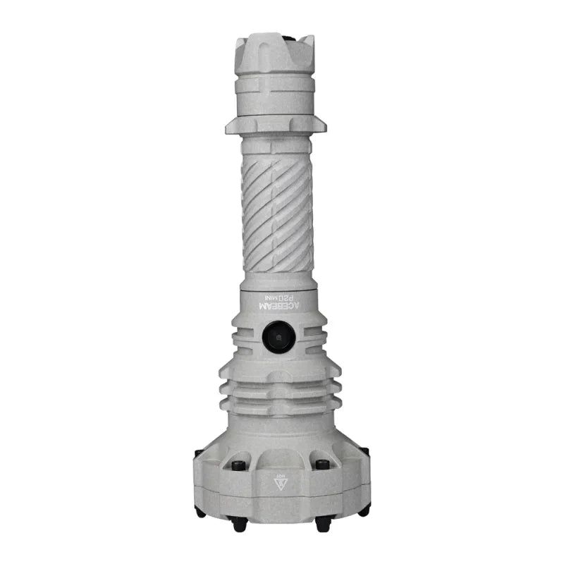 An Acebeam P20 Mini, a gray, cylindrical industrial flashlight featuring a textured grip, a black button, and a wide, sturdy base, stands upright against a white background—showcasing its rugged design for reliability and long-lasting performance.