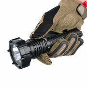 A gloved hand holds the Acebeam P20 Mini, a black tactical flashlight with a ridged body and reinforced bezel, positioned against a white background—showcasing the durability and design of this long distance flashlight.
