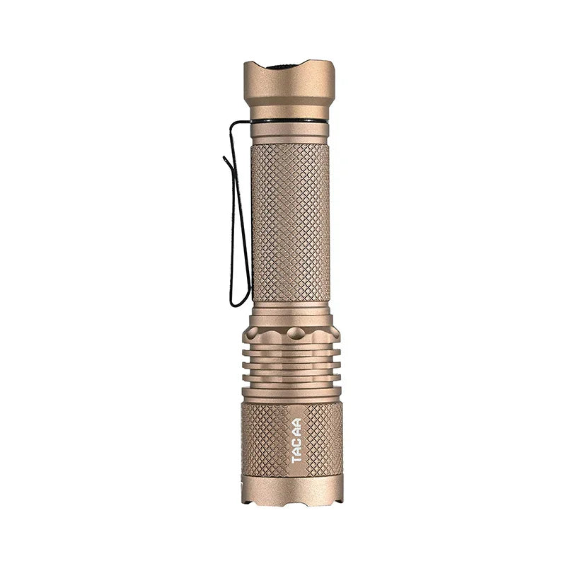 A metallic, tan-colored Acebeam TAC AA 2.0 tactical EDC flashlight featuring a textured grip, side clip, and the “TACAA” label on its lower section is displayed against a white background. This flashlight delivers up to 900 lumens of brightness for reliable performance in any situation.