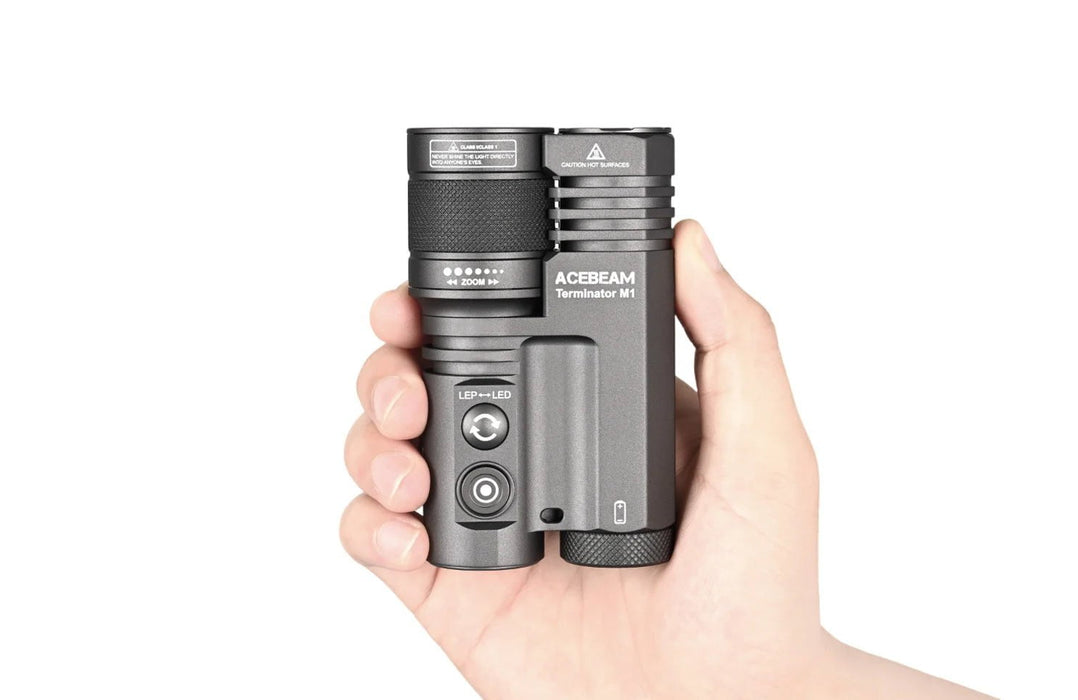 A person holding an Acebeam Terminator M1 Dual Head LEP Flashlight in their hand.