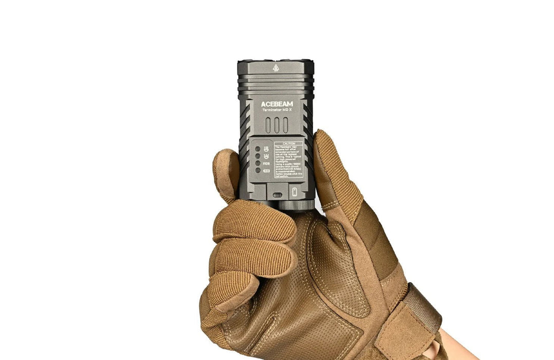 A hand holding a small flashlight in a leather glove, featuring the Acebeam Terminator M2-X With RGB.