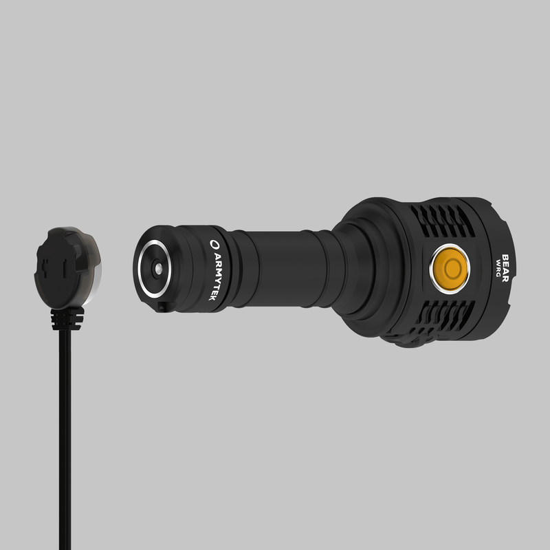 The Armytek Bear WRG, a black long-range flashlight featuring a yellow power button, is pictured with its detachable magnetic charging cable against a plain grey background. This rechargeable flashlight offers both durability and convenience for extended use.