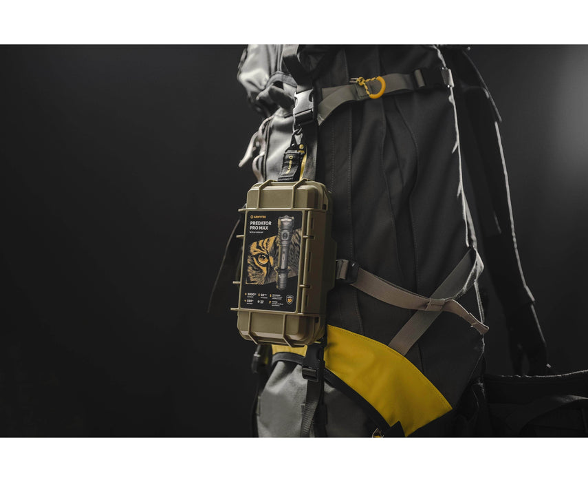 A rugged survival kit and the Armytek Predator Pro Max tactical flashlight are attached to the side of a gray and yellow backpack, set against a dark background.
