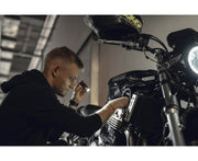 A man working with an Armytek Prime C1 Pro Magnet USB in a garage.