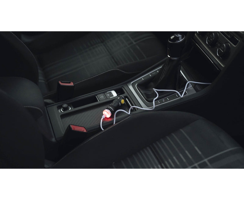 A car with an Armytek Prime C1 Pro Magnet USB in the center console.