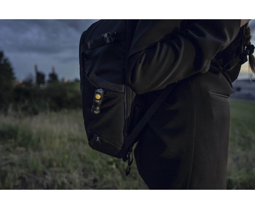 A person wearing a Armytek Prime C1 Pro Magnet USB attachded to a backpack.