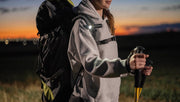 Hiker carrying an illuminated Elf C2 Max on a backpack strap