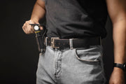 Elf C2 Max being placed in its belt-mounted nylon holster