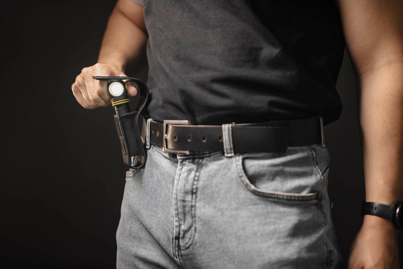 Elf C2 Max being placed in its belt-mounted nylon holster