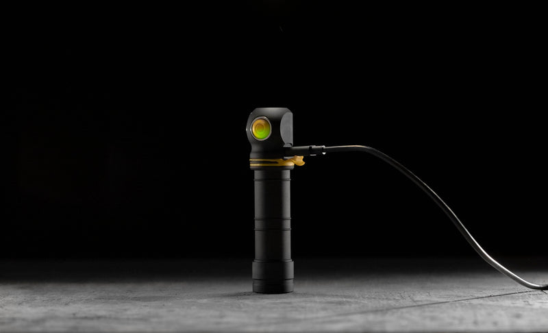 Elf C2 Max connected to a USB charging cable with its status button illuminated