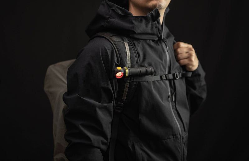 Elf C2 Max WR clipped horizontally to a backpack strap with red light on