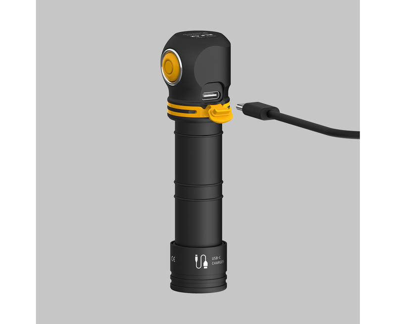 The Armytek Elf C2 USB-C Warm flashlight, featuring a right-angle head, is conveniently being charged via a USB-C cable.