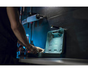 A man is using an Armytek Wizard C2 Pro Max LR - Warm tool box in a dark room.