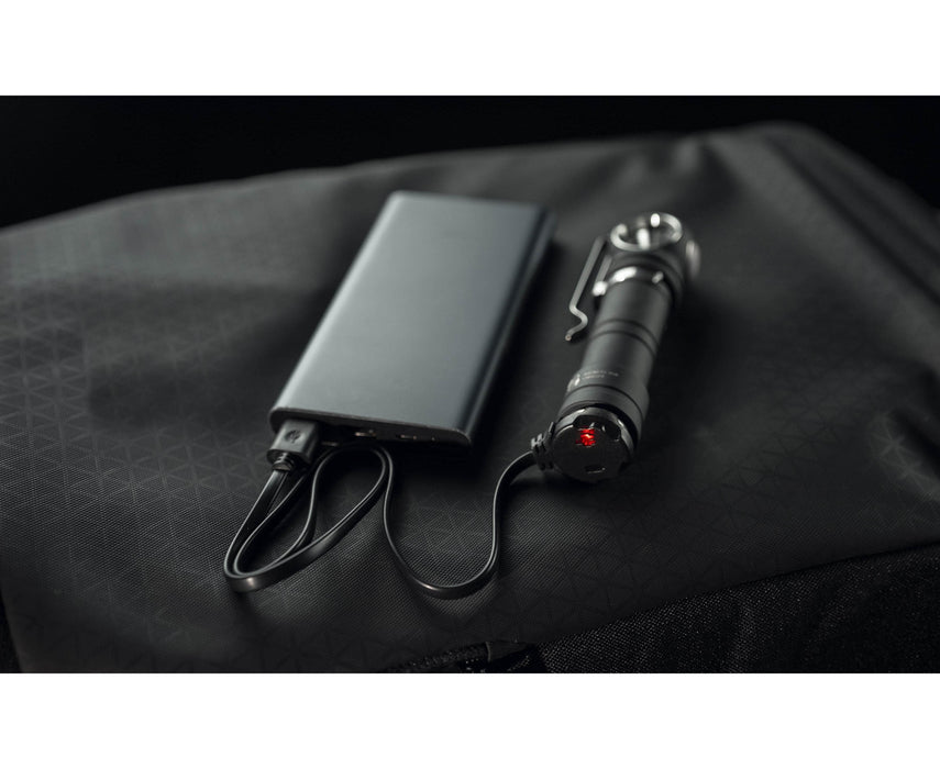 An Armytek Wizard C2 Pro Max LR - Warm power bank is sitting on top of a backpack.