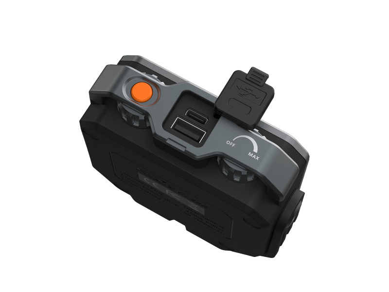 Aerial perspective of the Fenix CL28R, an electronic device in black and gray, showcasing an orange button, a USB port, and dial settings for seamless brightness control. This versatile outdoor lantern is equipped with an "OFF/MAX" label and features a detachable protective cover.