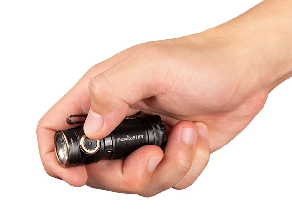 A person holding a Fenix E18R flashlight.