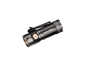 Black rechargeable LED flashlight with a copper button and clip, labeled "Fenix E18R V2," delivering 1200 lumens on a black background. Ideal for everyday carry (EDC).