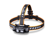 The Fenix HM60R is an outdoor headlamp in black and orange, equipped with an adjustable strap that prominently displays "FENIX." It features two circular lights capable of producing a remarkable 1300 lumens, ensuring bright illumination for your adventures.