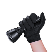 A gloved hand holds the Fenix HT18R flashlight, featuring a textured grip and an impressive 2800-lumen output, ideal for use as a Hunting Light.