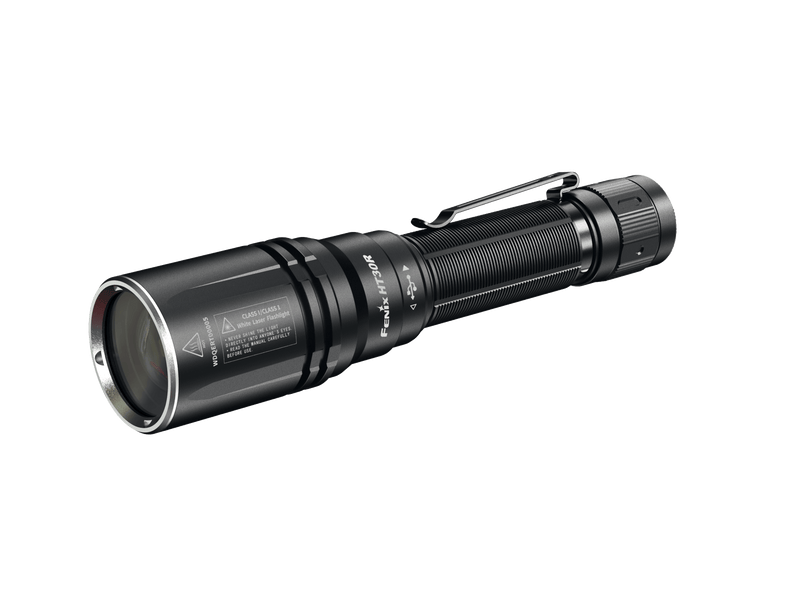 A tactical flashlight in black, crafted with a metal body and equipped with a clip, featuring detailed side labeling and precision distance capabilities similar to the Fenix HT30R.