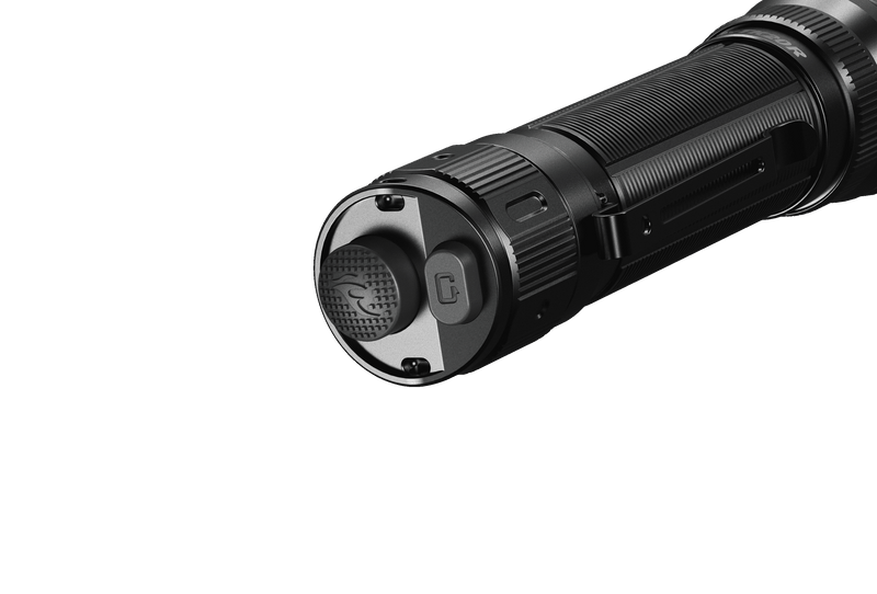 Close-up of the end cap and power button on the sleek black Fenix TK20R V2.0 tactical flashlight, emitting 3000 lumens, set against a shadowy backdrop.