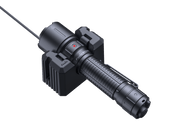 The Fenix WF26R, a black LED work flashlight, is positioned on a charging cradle with a wired connection. The dock features side grips and includes a small indicator light.