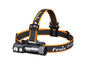 The Fenix HM71R is a black and orange rechargeable headlamp featuring dual LED lights and an adjustable strap, providing high-performance illumination at 2700 lumens with the Fenix brand logo.