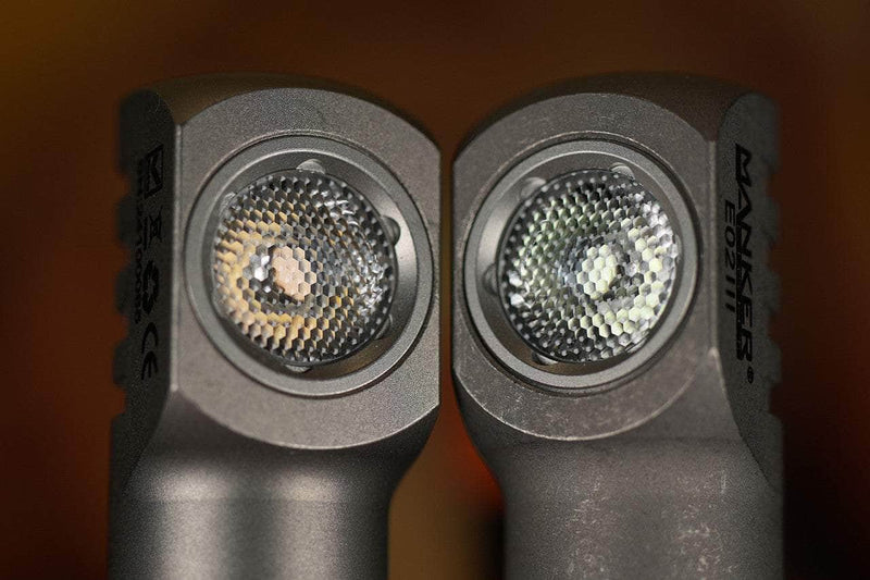 Close-up of two angled Manker E02 III - Titanium flashlights side by side, highlighting their textured lens covers and metallic bodies—each featuring a High CRI Nichia LED for brilliant 560-lumen illumination.