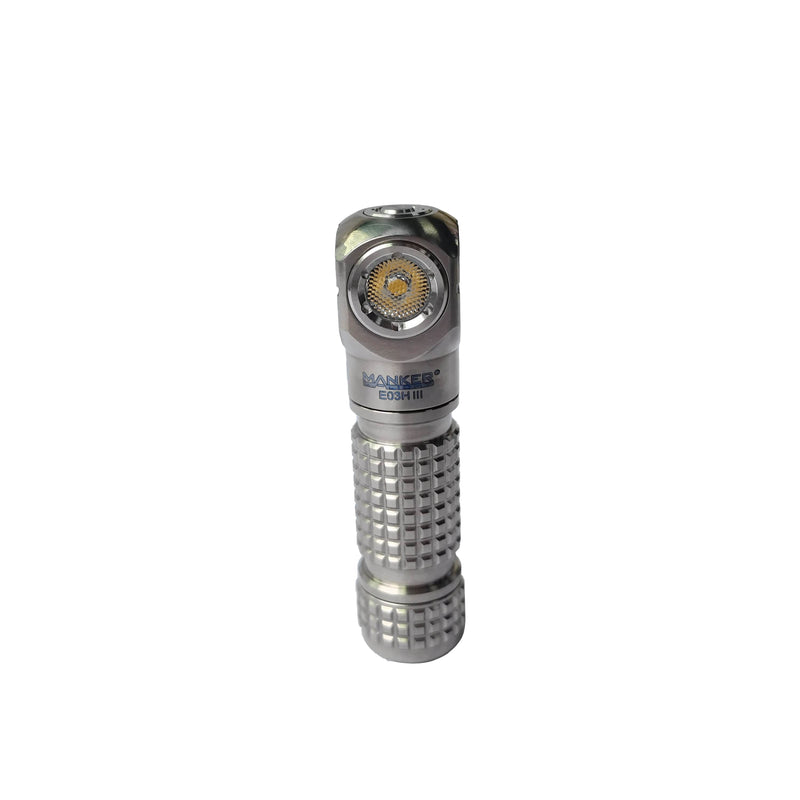 The Manker E03H III - Titanium is a compact everyday carry flashlight with a textured grip and a visible LED bulb, standing upright on a white background.