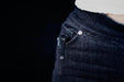 The pocket of a woman's jeans with a Manker E05 II.
