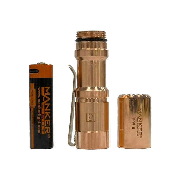 A compact Manker E05 II - Copper flashlight, equipped with two batteries for enhanced versatility.