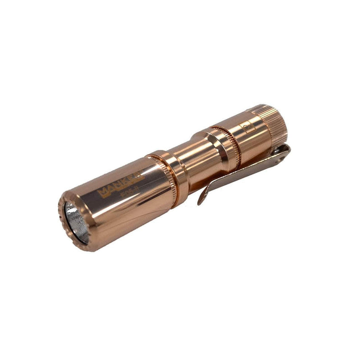 The compactness of the Manker E05 II - Copper LED flashlight is showcased against a white background.