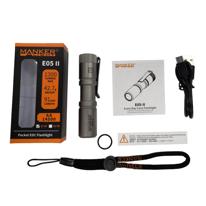 The Manker E05 II Ti - Beadblasted flashlight, delivering 1300 lumens, is displayed with its box, user manual, USB charging cable, wrist strap, and spare O-ring—an ideal everyday carry neatly arranged on a white background.