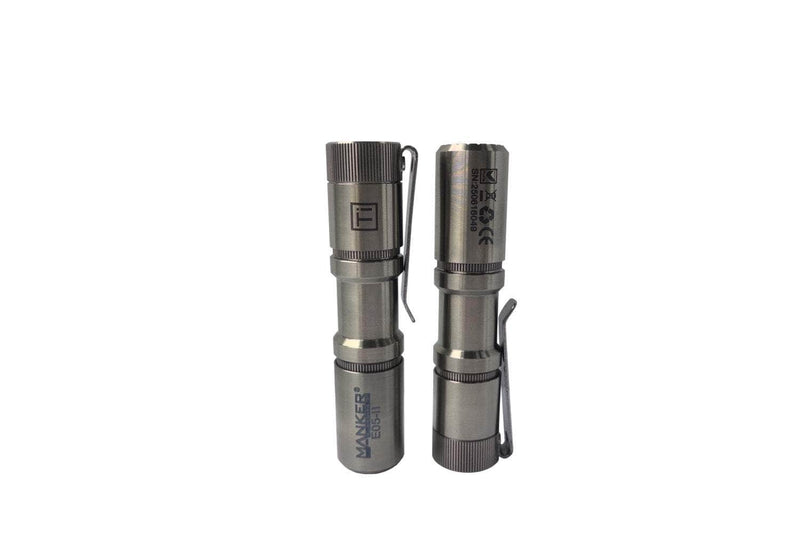 Two Manker E05 II - TI Raw silver, pocket-sized EDC flashlights with clip attachments are shown upright and side by side against a plain white background.