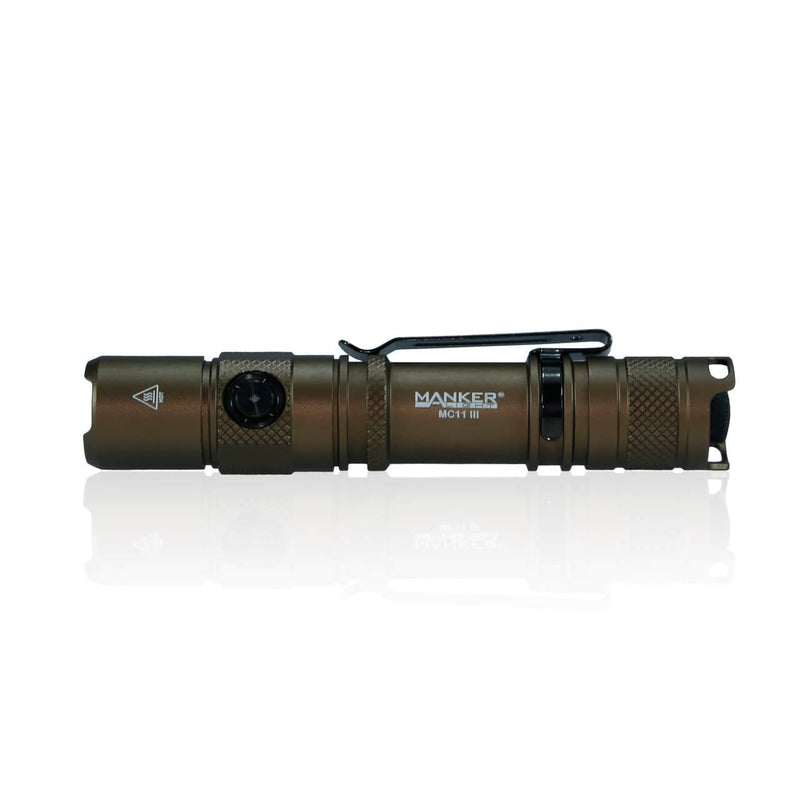 The Manker MC11 III USB-C Rechargeable Tactical Flashlight is a compact, bronze-colored everyday carry flashlight with a side button, belt clip, and textured grip, displayed on a white background.
