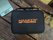 A Black Manker Ranger MK39 II carrying case sits on a wooden bench next to a digital scale reading "808," poised for action with its powerful spotlight capabilities.