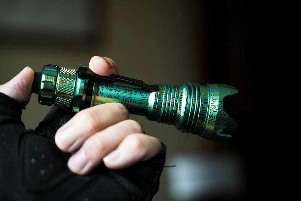 A person holding a Manker Striker Limited Edition flashlight in their hand.