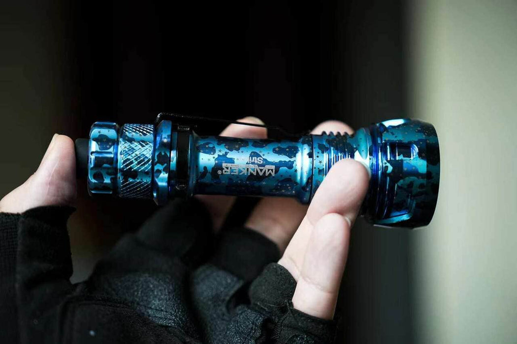 A person holding a Manker Striker Limited Edition flashlight in their hand.