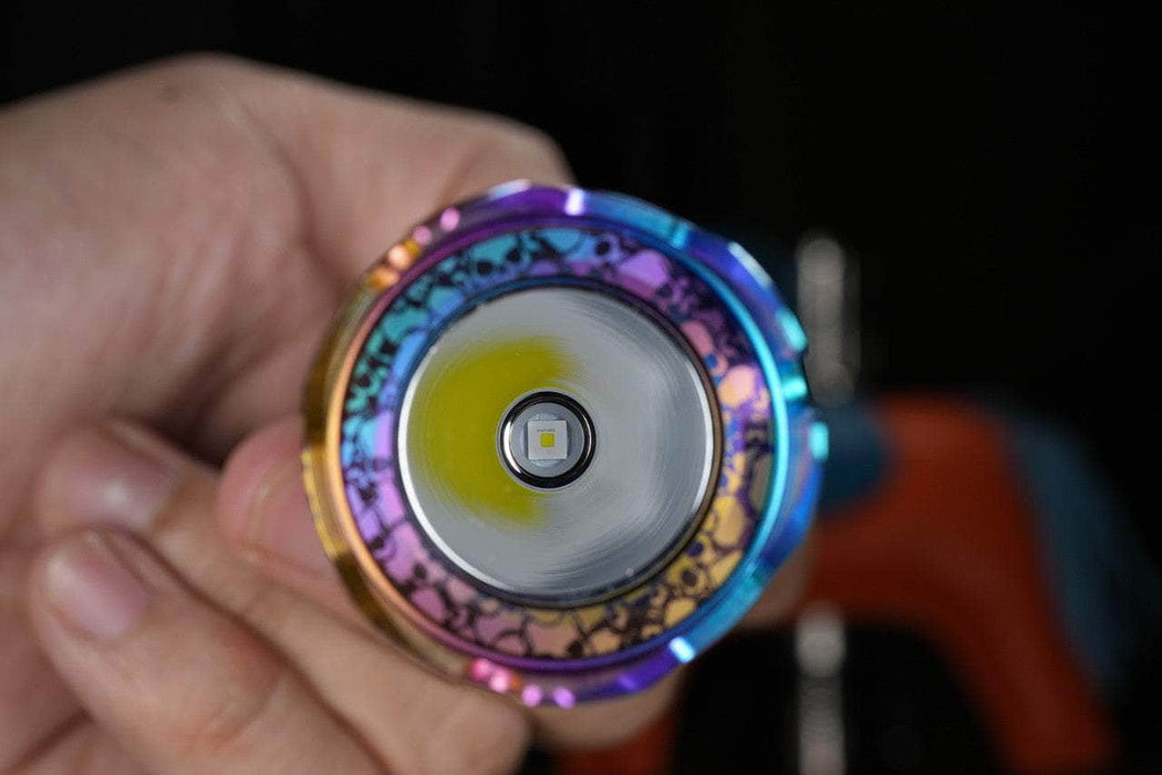 A person holding a Manker Striker Mini Titanium Color toy.