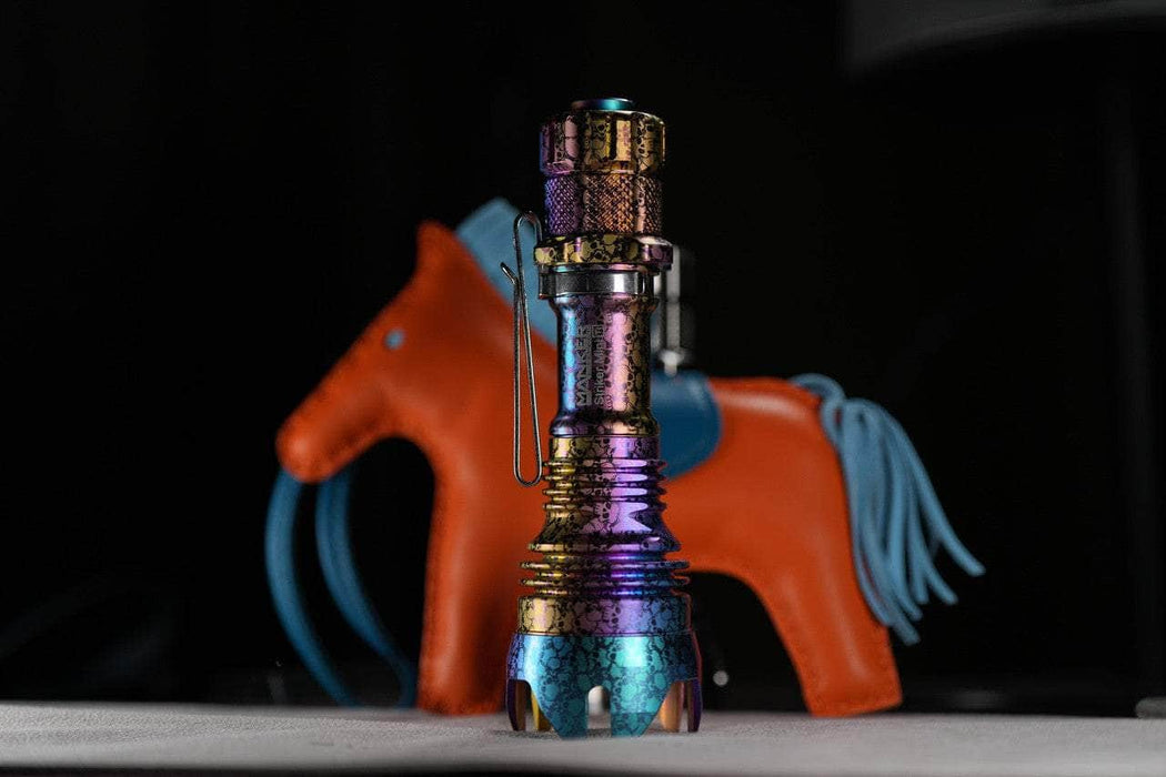 A Manker Striker Mini Titanium Color is sitting on top of a table.