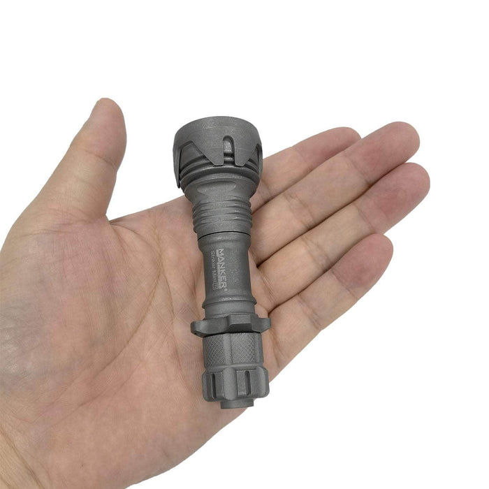 A compact and lightweight Manker Striker Mini Titanium EDC Flashlight holding a flashlight in their hand.