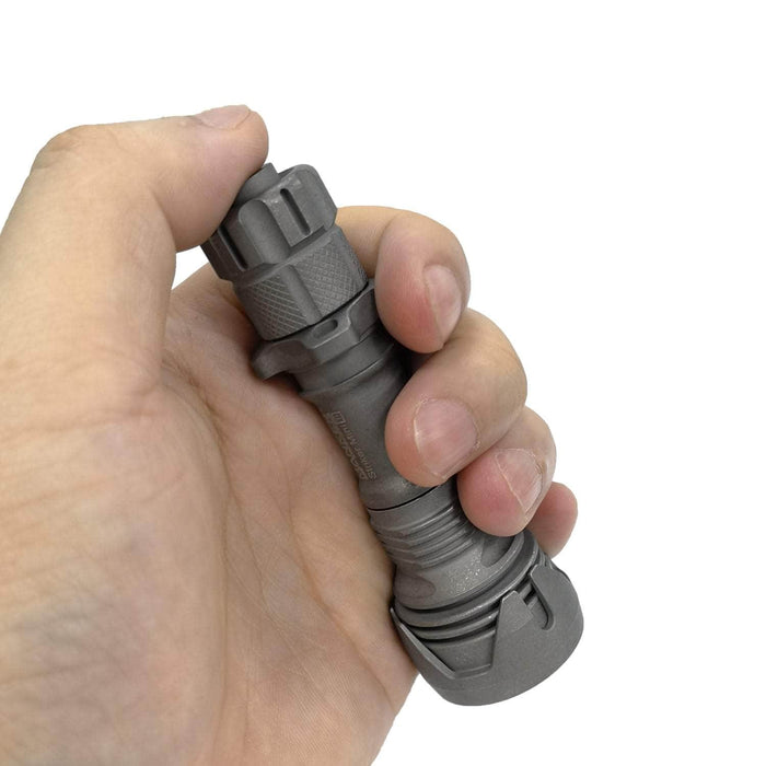 A person holding a Manker Striker Mini Titanium EDC Flashlight.