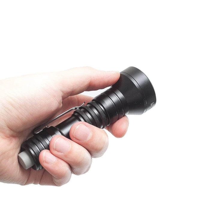 A hand holding the Mankerlight MC12 II Hunter Flashlight, a small black flashlight with USB Type-C charging and a rechargeable lithium-ion battery, against a plain white background.
