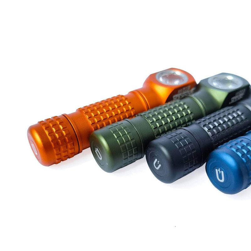 Four Manker E02 III AAA / 10440 flashlights in orange, green, black, and blue—each with a high-performance LED—are arranged diagonally on a white background.