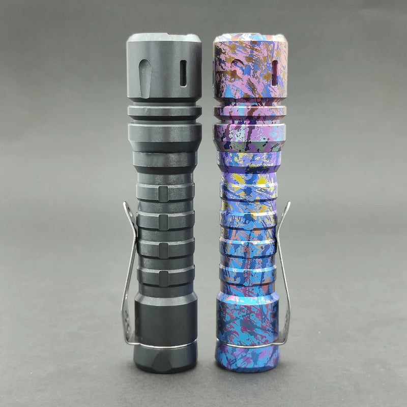 Two metal flashlights on a gray background: The left one is solid black with an XPL HI 6000K LED for superior brightness. The right one, ReyLight Anodized Ti LANapple, showcases a striking blue and purple multicolor splatter design. Both have convenient clip attachments.
